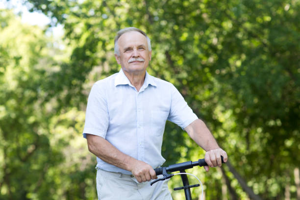 istock senior man riding a scooter in the park. Active Seniors 1274612683