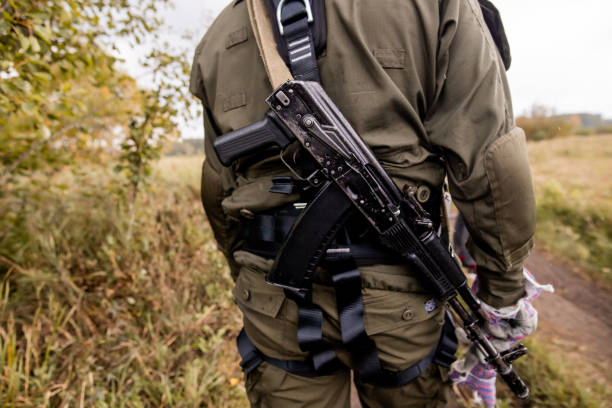 Soft focus. Soldier in camouflage holding a finger on the trigger of a Kalashnikov, Special forces team. Russian police (Spetsnaz). Soft focus. Soldier in camouflage holding a finger on the trigger of a Kalashnikov, Special forces team. Russian police (Spetsnaz). spetsnaz stock pictures, royalty-free photos & images