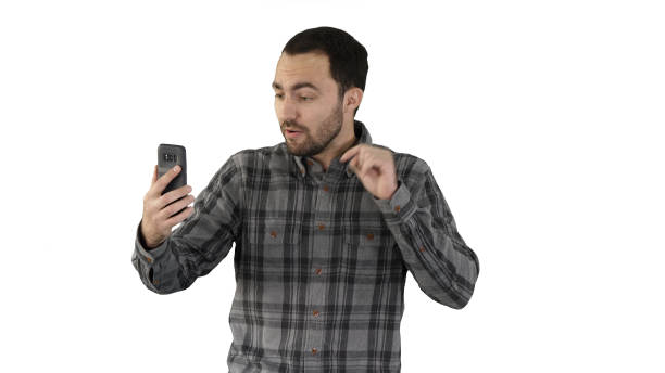 istock Young blogger recording video on his phone while walking on whit 1274628081