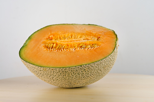 Ripe sweet melon cut into half with clean background
