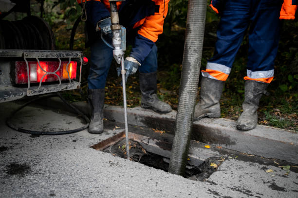 istock Cleaning storm drains from debris, clogged drainage systems are cleaned with a pump and water 1274630819