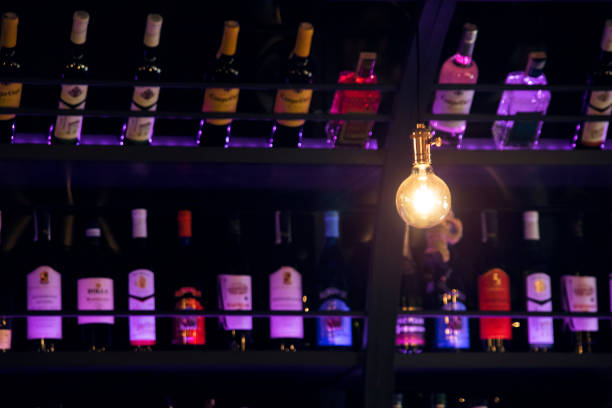 istock A light bulb against a bar counter with bottles of wine 1274637371