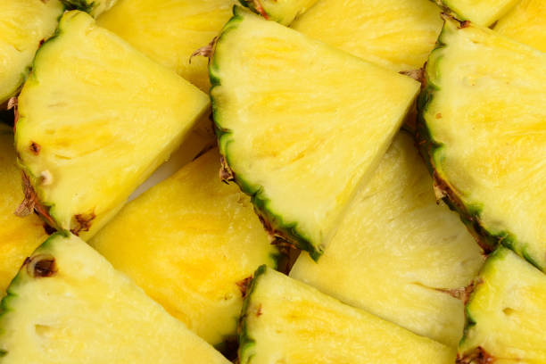 istock Pineapple juicy yellow slices background. Top view. 1274642324