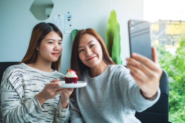 istock Women using mobile phone to take a selfie 1274643010