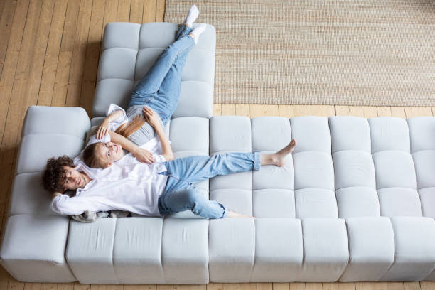 istock Top view of couple relaxing on sofa. 1274654080