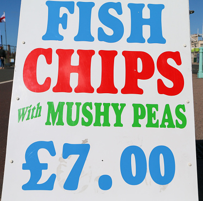 Fish & Chips with Mushy Peas costing £7 Sign in Brighton, England
