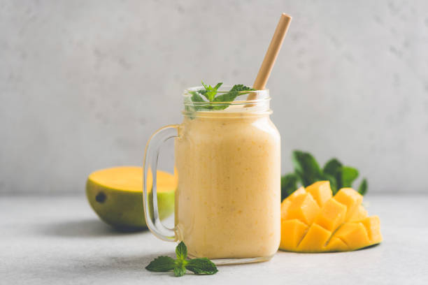 istock Delicious mango smoothie in glass jar 1274658583