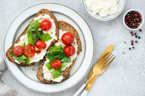 istock Tomato bruschetta with ricotta cheese and lettuce salad 1274658596