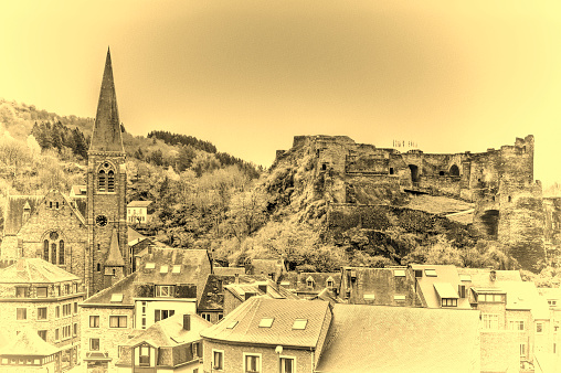 View of the Church and the Castle in the Belgian City of La Roche. View of the town centre below its medieval Castle in of La Roche. Vintage Style Toned Picture