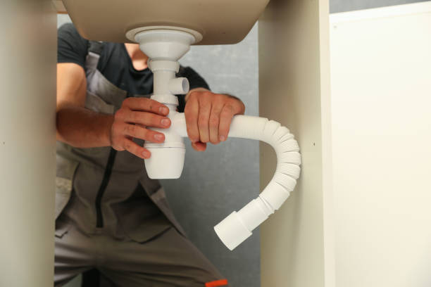 istock plumber installs a siphon pipe on the kitchen sink. 1274667880