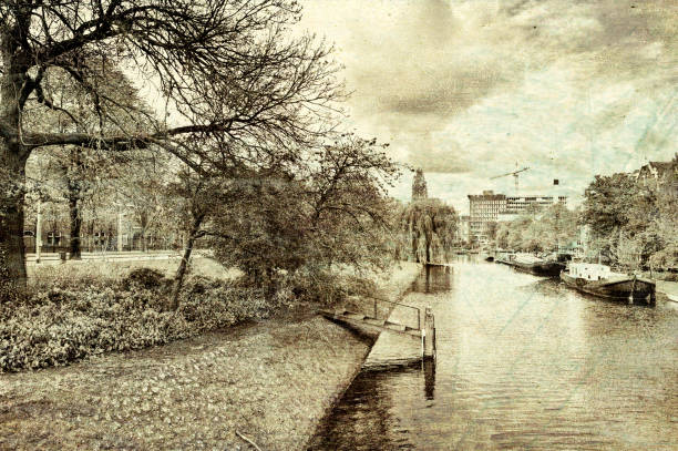 Urban scene in Amsterdam with typical local architecture. Embankment in the historical center of Amsterdam in the Netherlands. Vintage style toned picture