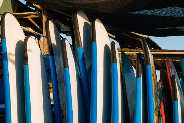istock Close up stack of blue color soft surfboards in a stack by ocean.Bali.Indonesia. Surf boards on sandy beach for rent. Surf lessons on Weligama beach, Sri Lanka. 1274679694