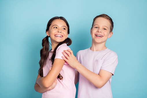 Photo of positive cheerful two kids boy girl happy family concept, wear good look clothes isolated over blue color background