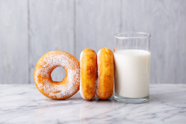 istock Donuts with glass of milk on marble table. Grey background. Close up. 1274691585