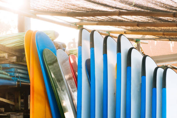 istock Set of different color surf boards in a stack by ocean.Bali.Indonesia. Surf boards on sandy beach for rent. Surf lessons on Weligama beach, Sri Lanka. 1274693615