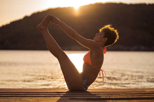 istock Woman stretching on the lake 1274697493