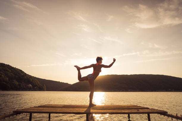 istock Woman stretching on the lake 1274698441