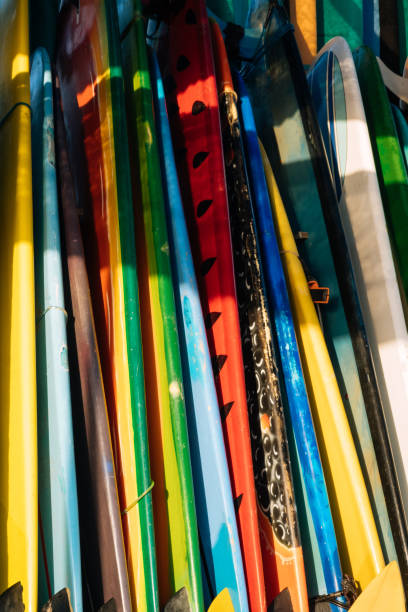 istock Set of different color surf boards in a stack by ocean.Bali.Indonesia. Surf boards on sandy beach for rent. Surf lessons on Weligama beach, Sri Lanka. 1274698569