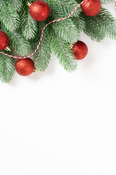 istock Christmas background. Red decorations on spruce branches on a white background. Christmas Flatly. Top view from copyspace 1274699701