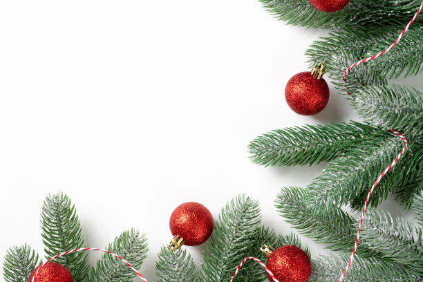 istock Christmas background. Red decorations on spruce branches on a white background. Christmas Flatly. Top view from copyspace 1274699710