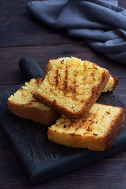 istock Slices toast wheat bread on a dark wooden background. Copy space. 1274699800