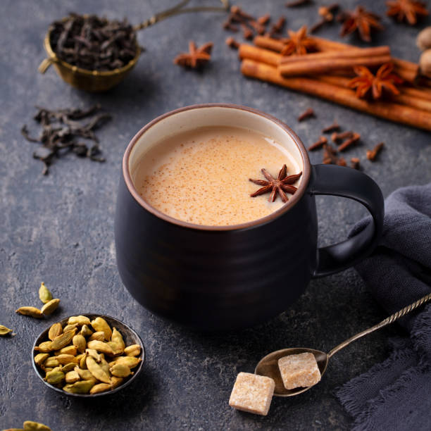 istock Indian masala tea with milk and spices in mug. Grey background. Close up. 1274706026