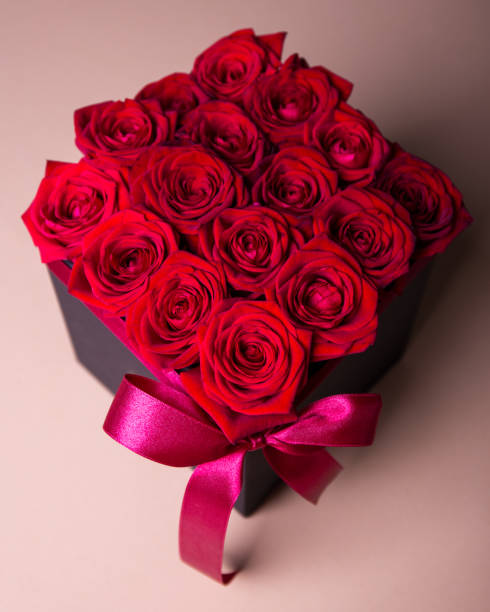 istock close up of box with red roses over beige background 1274708544