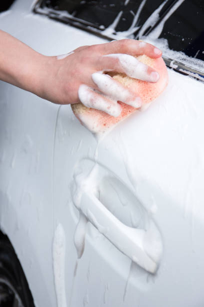 istock male hand washing car with sponge and foam 1274708956