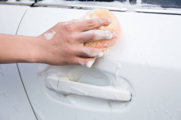 istock handle carwash concept - man washing car with sponge 1274709026
