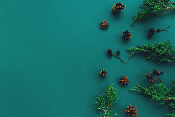 istock Creative winter composition with pine cones, fir tree and balls on green background with sequins.Christmas celebration and party concept. 1274715217