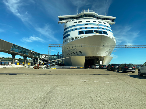 Stockholm, Sweden - July 26, 2020:  Wide front view of many cars entering the bow of the Tallink Silja Line cruise ship ferry moored in the port of Vartahamnen, Stockholm Sweden July 26, 2020.