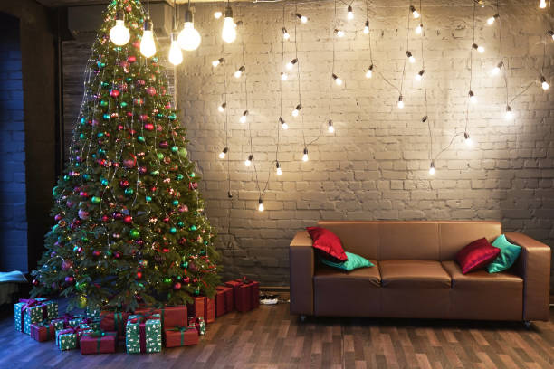 istock lighted Christmas tree with presents underneath in living room 1274725815