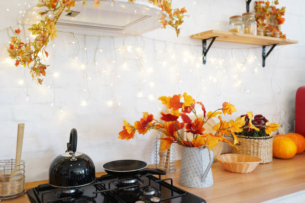 istock Autumn kitchen interior with pumpkin, fallen leaves, Thanksgiving dinner preparation 1274726402