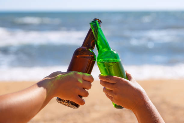 istock hands with glass bottles of beer making toast 1274728409