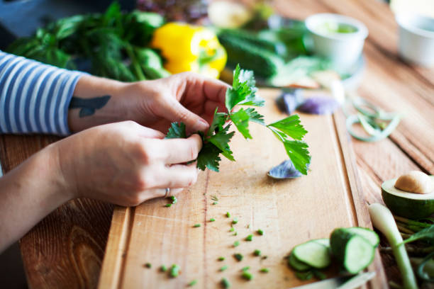 istock slicing greens on wooden cutting board 1274728751