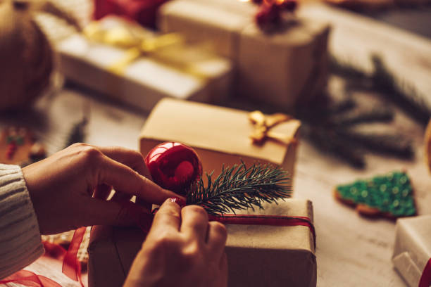 istock Unrecognizable woman decorating a Christmas gift box 1274739888