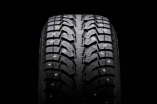 istock winter studded tire for snow and ice. directional tread pattern. close-up on a black background, close-up 1274741063