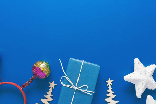 istock Christmas present. Gift in a blue box on a blue background, top view 1274785011