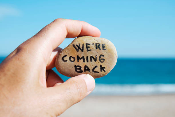 istock man on the beach and text we are coming back 1274786256
