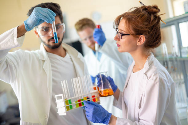 istock Serious clinicians studying chemical elements in laboratory 1274796298