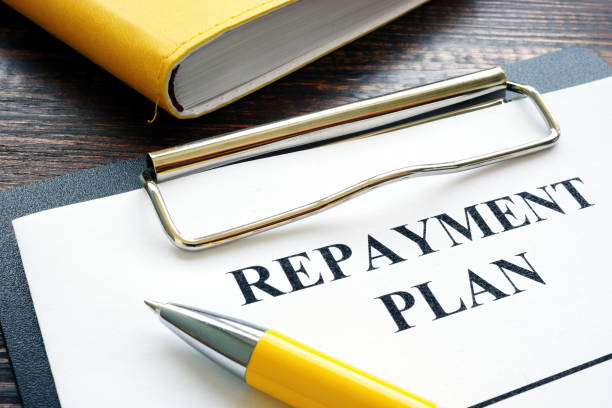 repayment plan with clipboard and pen