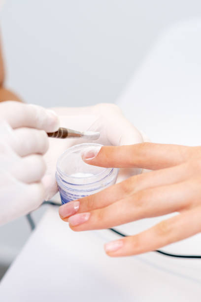 istock Process of applying acrylic powder on the nails 1274818585