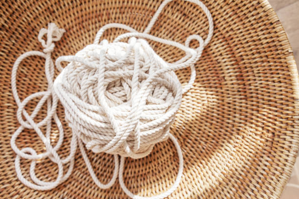 istock Cotton rope for handmade macrame in a woven basket. Female hobby. Copy space 1274825235
