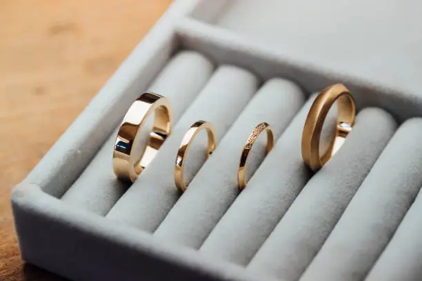 A collection of handcrafted golden rings on display in a jewelry store. / Female Focus Collection