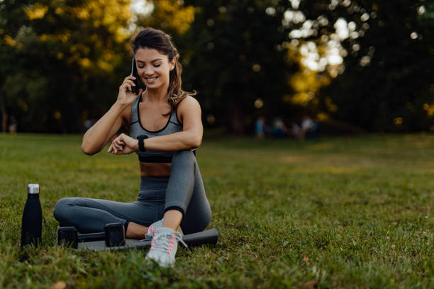 istock Making a phone call, looking at wrist watch. 1274828993