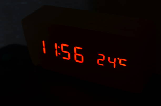 istock Time and temperature on black background of electric clock 1274829293