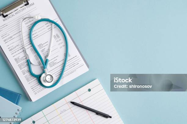Top View Of Medical History Form In Clipboard Stethoscope And Other Stuff Stock Photo - Download Image Now