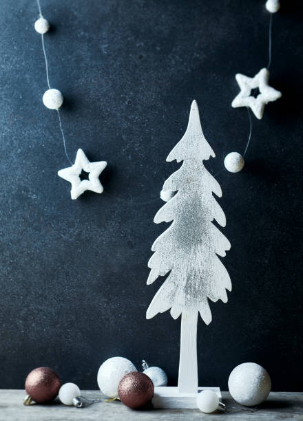 istock An arrangement of white Christmas decorations over dark background. Copy space 1274838094