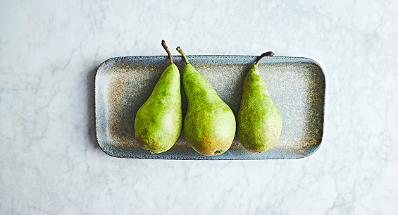 Conference pears on a ceramic plate. Flat lay