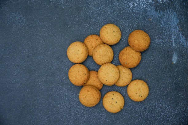 istock biscuits isolated on dark background.Atta biscuit, cookies, white flour biscuit - Indian cooking 1274845264